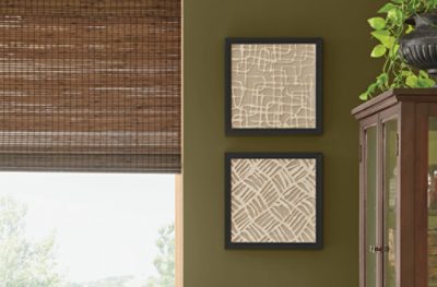 A wall painted Palm Leaf SW 7735, paired with decorative pictures and a window.