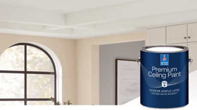 A bright room featuring an arched window, light-colored cabinetry, and a white-painted open-beam ceiling. And a can of Premium Ceiling paint in the foreground.