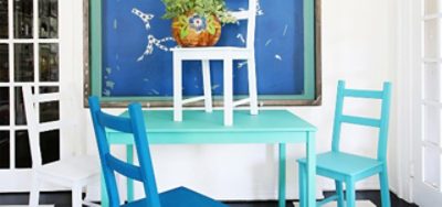 A set of wooden chairs and a table painted bright blue and green
