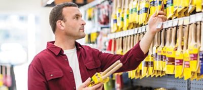 A man is shopping for Purdy paint brushes.