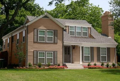 A coastal home with light brown paint colors and dark trim. S-W colors featured: SW 6102, SW 7632, SW 7047