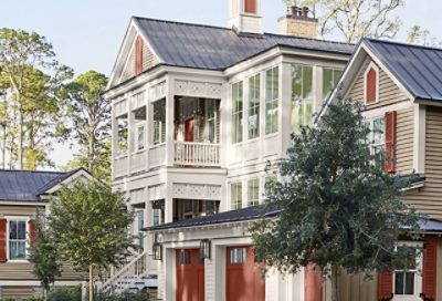 A coastal home with burnt orange garage doors and cream-colored paint. S-W colors featured: SW 7507, SW 7628, SW 2839