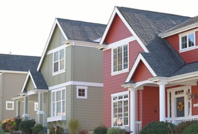 A green and red house with a black roof.