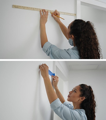 A woman measuring a wall before painting.