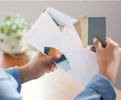 Person opening envelope full of color chips. 