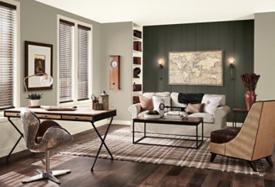 A traditional living room with an office space and hardwood floors.