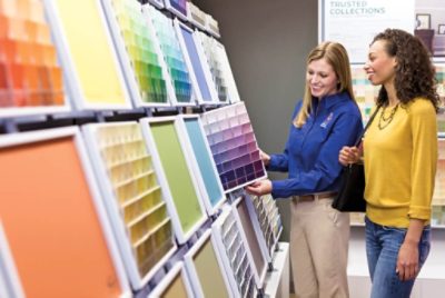 A Sherwin-Williams store employee helping a customer with color.