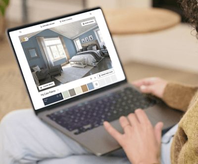 A person using the Sherwin-Williams Color Visualizer on a laptop.