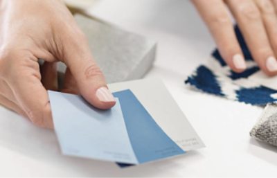 Person holding three different color chips.