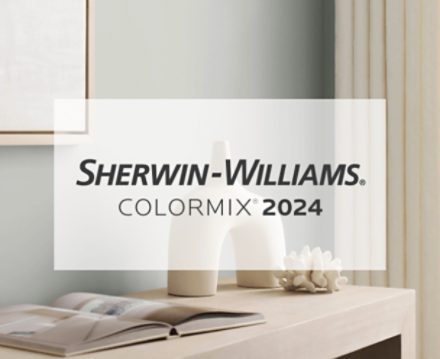 Sherwin-Williams Colormix® 2024. A light gray wall behind a console table holding an open book and modern decor.