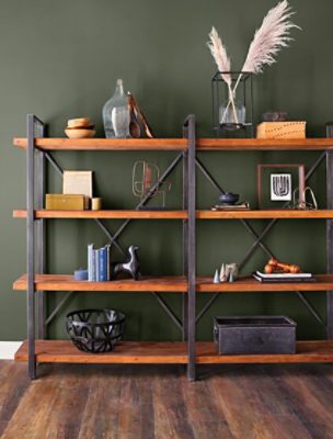 A large bookshelf against an earth-toned wall.