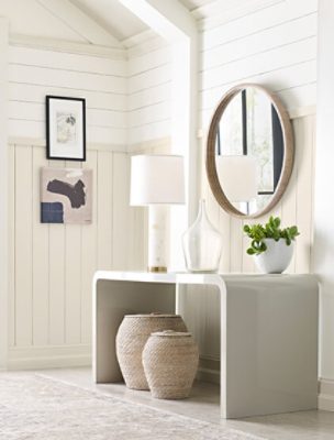 A white entryway with shiplap walls and vaulted ceiling.