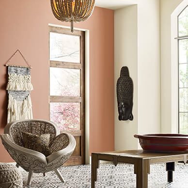 A sitting area with unique flower chairs and two neutral color walls.