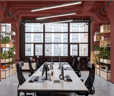 An industrial style conference room with walls and exposed ceiling painted Rookwood Red SW2802.