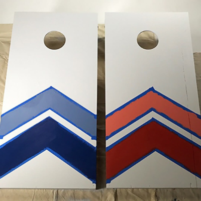 Two freshly painted cornhole boards