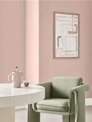 A mid-century modern inspired dining area in front of a wall painted Sashay Sand.