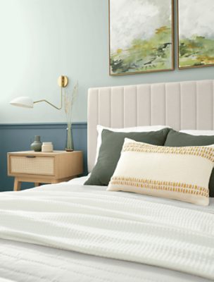 Two toned bedroom painted in SW 0068 Copen Blue with neutral decor.