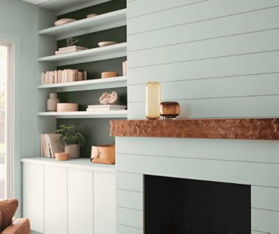 Living room painted in SW 0068 Copen Blue with built-ins and a fireplace