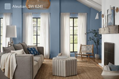 A living room with a vaulted ceiling and a white brick fireplace painted Aleutian SW 6241.