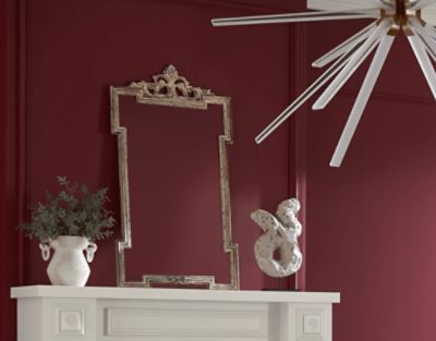 Walls painted in SW 7578 Borscht, white fireplace with decor on top.