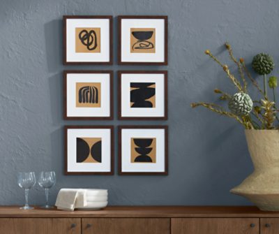 Wall painted in SW 6249 Storm Cloud with six prints above a credenza with plates and glasses and vase.