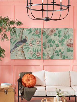 Board and batten wall painted in SW 6611 Jovial with two large floral prints and a black metal chandelier.