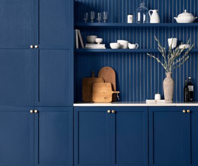 Kitchen cabinets with built in floating shelves all painted in SW 6524 Commodore. 
