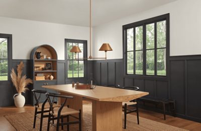 A dining room with lower walls and trim painted Iron Ore.