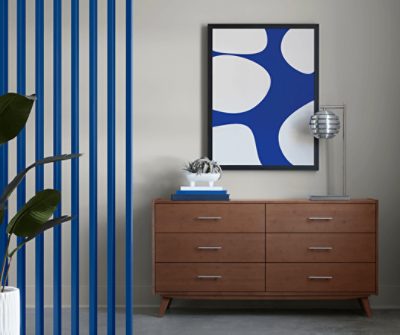 Wooden furniture with drawers, minimal decor, vertical slats painted in SW 6967 Frank Blue to the left.