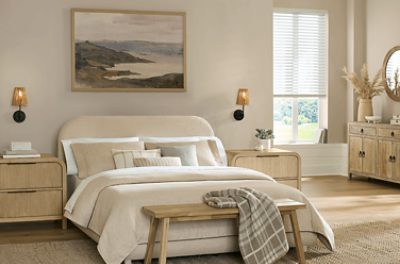 Bedroom painted in SW 9173 Shiitake, neutral bedding and nightstands, minimal decor.
