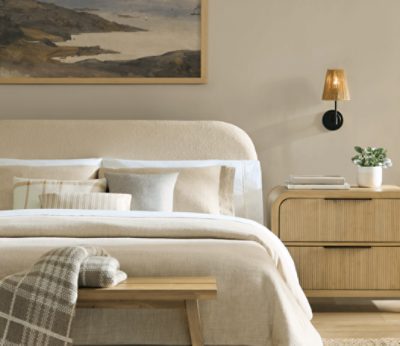 Bedroom painted in SW 9173 Shiitake, neutral bedding and nightstands, minimal decor.
