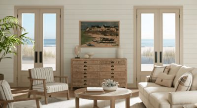 Living room painted in SW 9173 Shiitake, 2 double doors with natural light, neutral furniture.