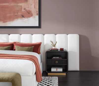 Bedroom painted in Chinchilla SW 6011 with white headboard and white bedspread with dark nightstand.