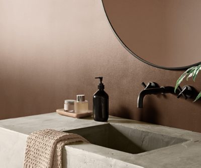 Concrete bathroom vanity against a wall painted in SW 6090 Java.