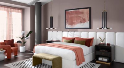 Bedroom painted in Chinchilla SW 6011 with white headboard and white bedspread with dark nightstand.