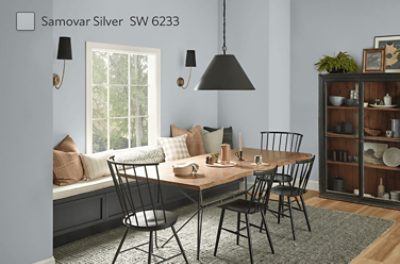 Dining room with a wooden table, black chairs, shelves, and walls painted SW 6233 Samovar Silver.