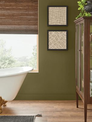 Bathroom walls painted in Palm Leaf SW 7735, footed tub with glass dresser and window.