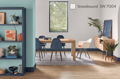 A partial wall painted a robin's egg blue looking into a dining area painted Snowbound SW 7004.