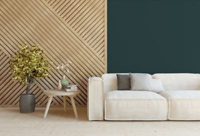 A cream couch in front of an accented wall. SW colors featured: SW 7623.
