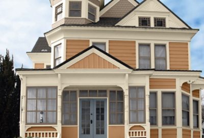 A gold craftsman home with white trim and gray accents. S-W colors featured: SW 0009, SW 2829, SW 0024, SW 2819.