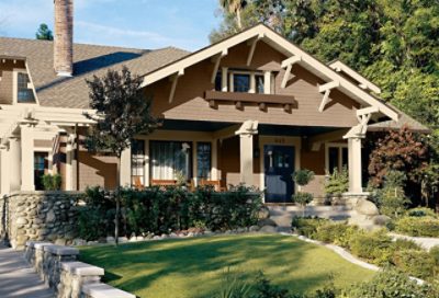 A brown craftsman home with trim and a blue entry door. S-W colors featured: SW 2835, SW 2833, SW 2806, SW 6244.