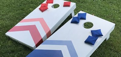 Two cornhole boards in a yard