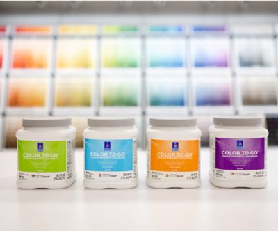 Four Color to Go paint samples on the counter of a Sherwin-Williams store. 