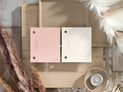 (left) light pink and white paint chips on top of wood, surrounded by feathers.