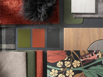 (left) green, orange, and black color chips laid out near materials and fabrics of a similar palette.