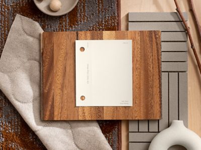 (left) white paint chip on a wooden piece with neutral materials surrounding.