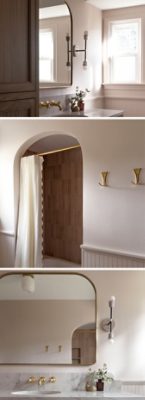 Modern bathroom with dark wooden vanity, archway shower, and gold fixtures in Unfussy Beige by Sherwin-Williams.