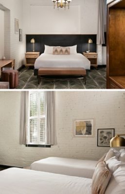 Hotel room with a large bed, elegant furnishings, and decorative elements with a two-toned focal wall painted Greek Villa and Greenblack.