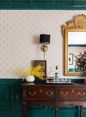 dark green dining room with patterned wallpaper.