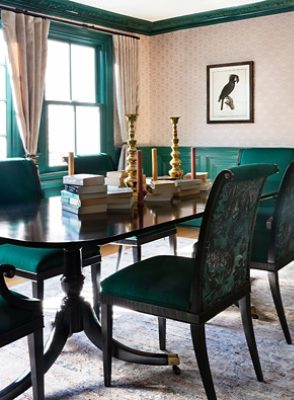 dark green dining room with patterned wallpaper.